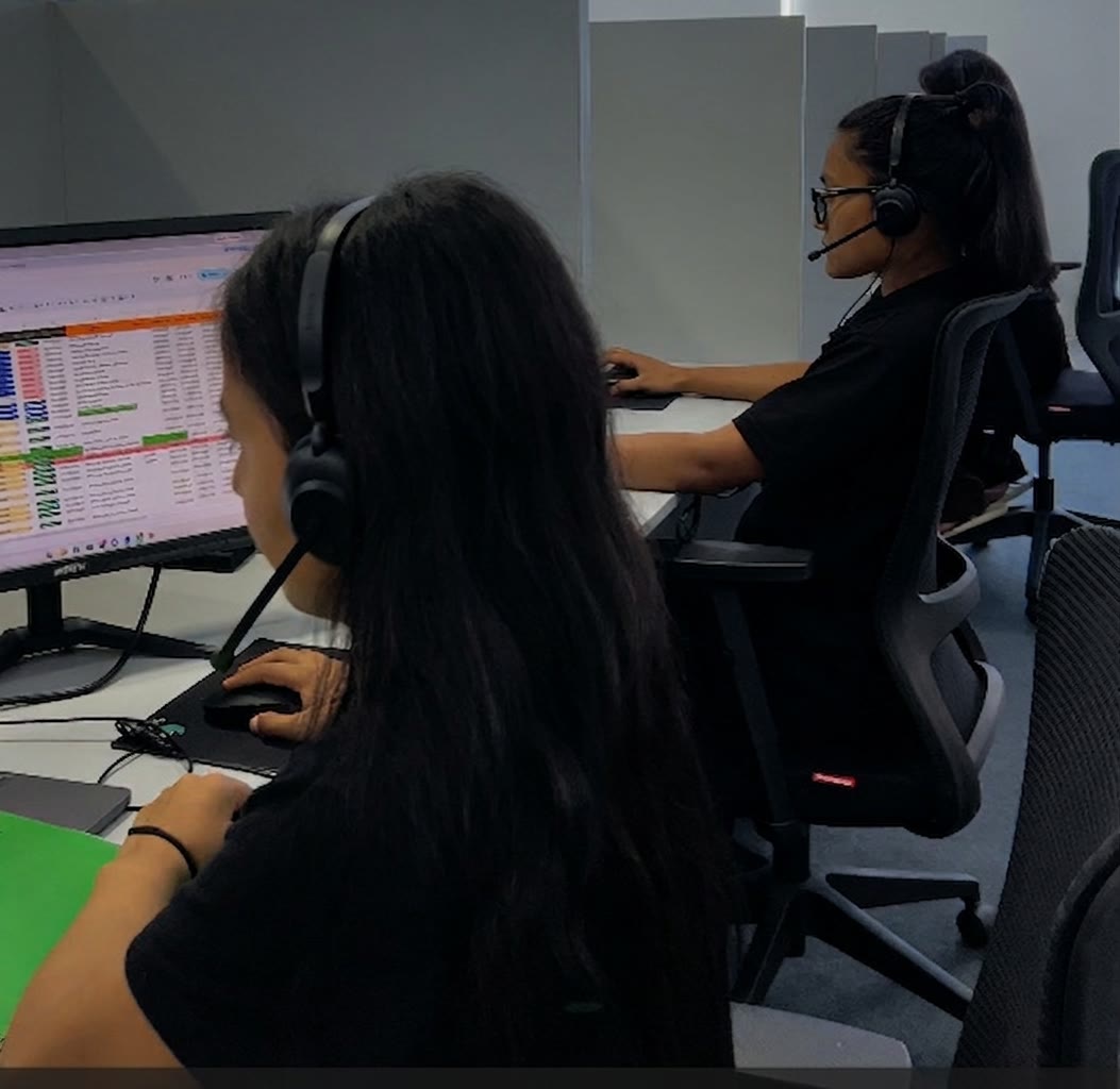Two Expand Quickly team members on the phones at the Kathmandu office